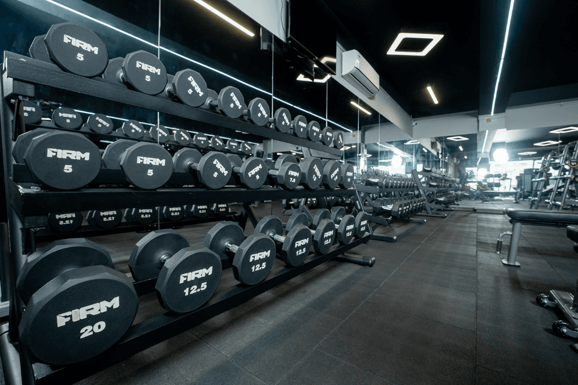 A row of modern treadmills and cardio equipment.